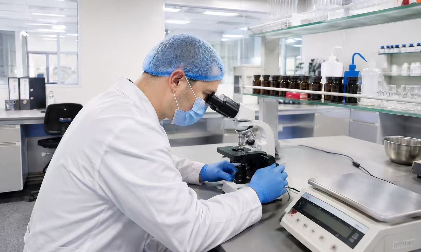 A Goldenroo technician examining a sample under a microscope in an Australian laboratory