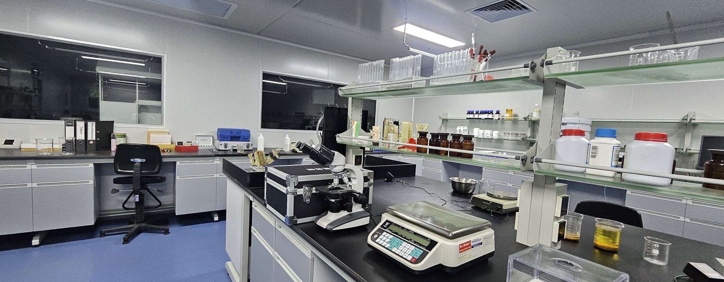 Laboratory benches with a microscope, precision scales and sample bottles